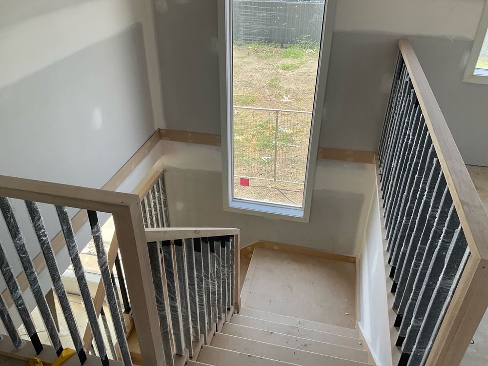 Stair handrail left rough, needing a proper sand before paint goes on, found during a fixing inspection in Kalkallo