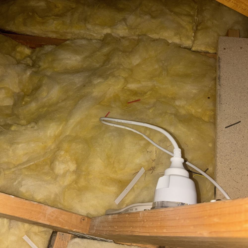 Insulation packed around a downlight without the clearance that stops overheating, found during a pre-purchase inspection in Kalkallo