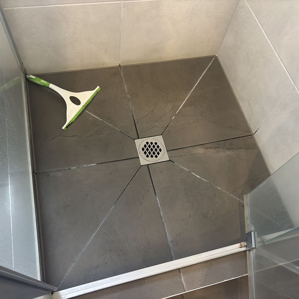 Shower grout degraded after an earlier leak, with ceiling damage patched below, found during a pre-purchase inspection in Kalkallo